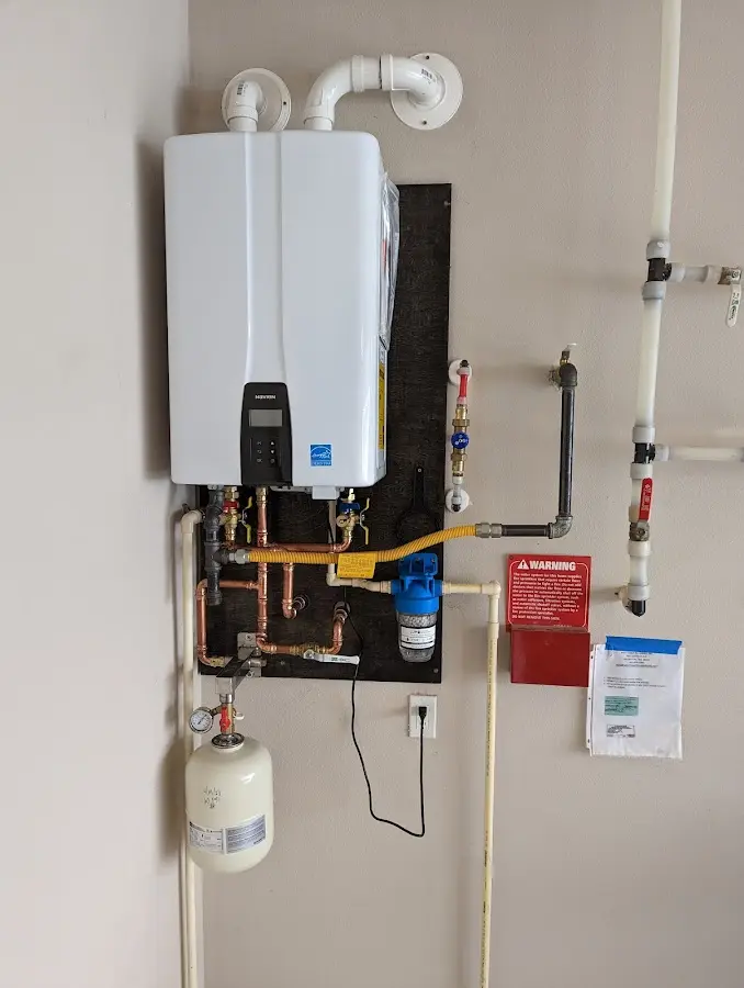 Professional plumber installing copper piping in a Westmont home